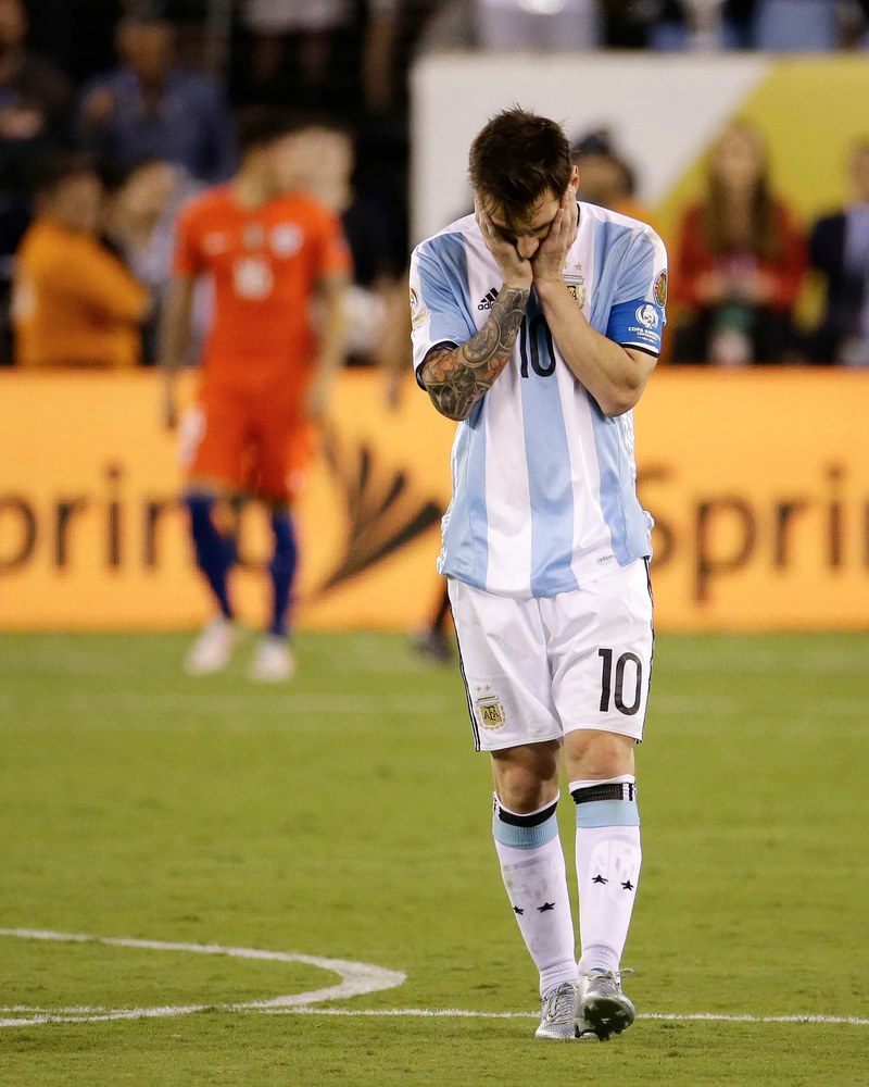 Lionel Messi with his hands over his face after losing the 2016 Copa América Final