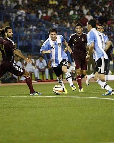 Lionel Messi dribbling past Venezuela players at the Salt Lake Stadium in Kolkata