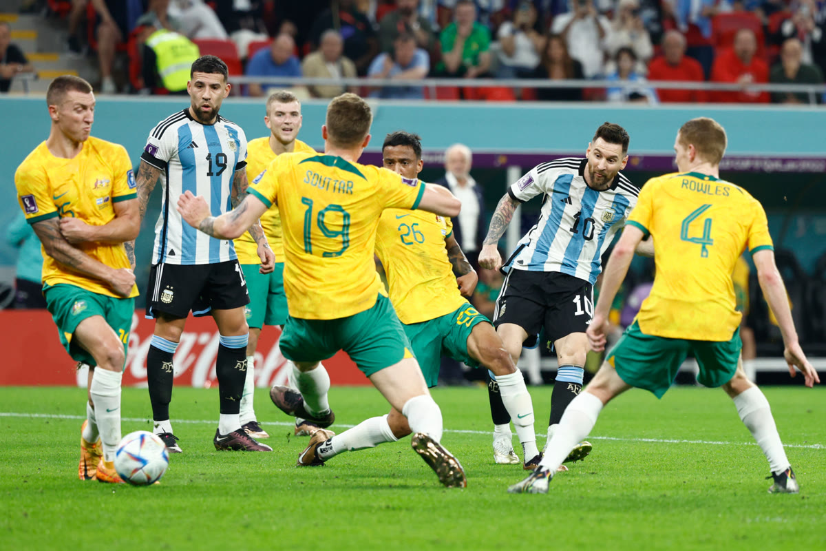 Lionel Messi shooting past Australian defenders at the 2022 World Cup